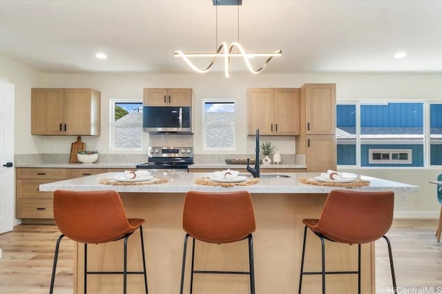 1504 Ainakoa Ave, Honolulu, HI 96821 - kitchen featuring appliances with stainless steel finishes, a kitchen bar, light countertops, a chandelier, and recessed lighting