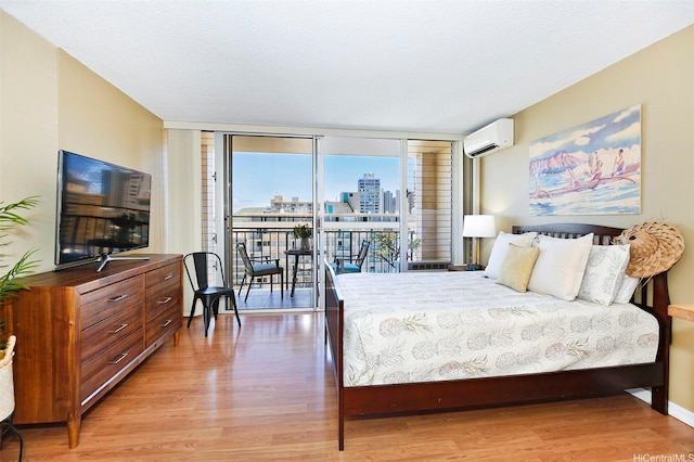 2345 Ala Wai Blvd Unit 1805, Honolulu, HI 96815 - bedroom featuring a wall unit AC, light wood finished floors, access to outside, a view of city, and a wall of windows