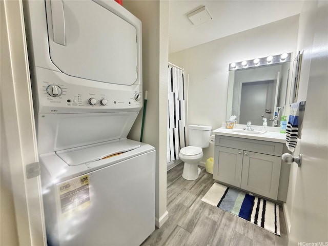 95-510 Wikao St Unit B201, Mililani, HI 96789 - full bath featuring stacked washer and clothes dryer, wood finished floors, vanity, toilet, and baseboards