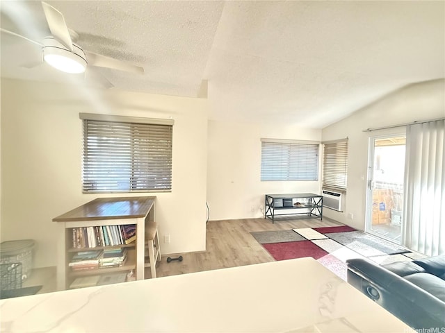 95-510 Wikao St Unit B201, Mililani, HI 96789 - bedroom with access to exterior, wood finished floors, a textured ceiling, and lofted ceiling