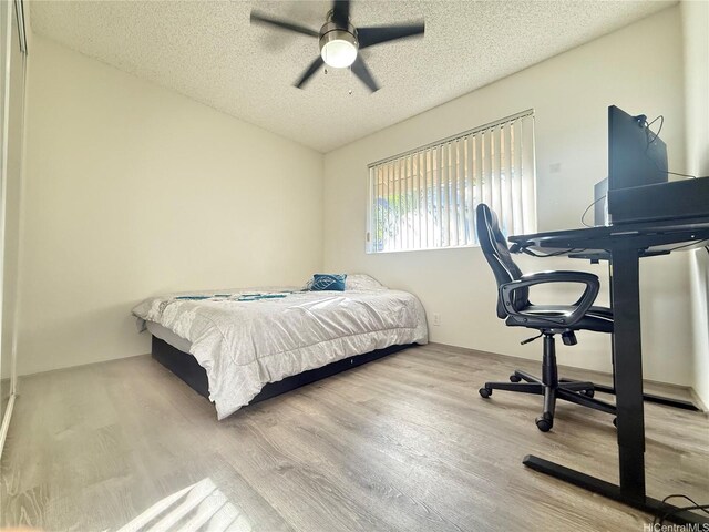 95-510 Wikao St Unit B201, Mililani, HI 96789 - bedroom with wood finished floors, a textured ceiling, and ceiling fan