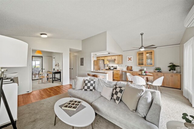 98-1712 Kaahumanu St Unit 11A, Pearl City, HI 96782 - living room with vaulted ceiling, a textured ceiling, a wall mounted AC, ceiling fan, and light colored carpet