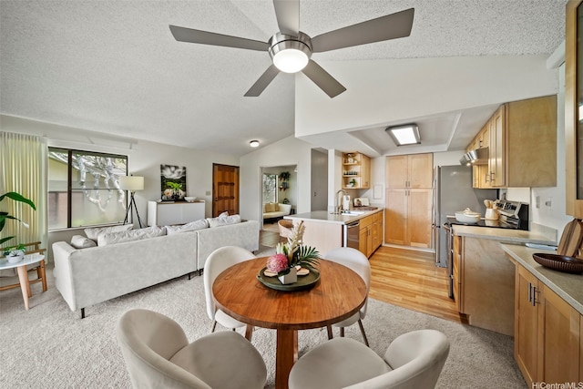 98-1712 Kaahumanu St Unit 11A, Pearl City, HI 96782 - dining space featuring a textured ceiling, vaulted ceiling, a ceiling fan, and light carpet