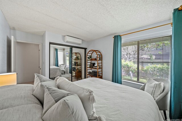 98-1712 Kaahumanu St Unit 11A, Pearl City, HI 96782 - bedroom with a wall mounted air conditioner and a textured ceiling