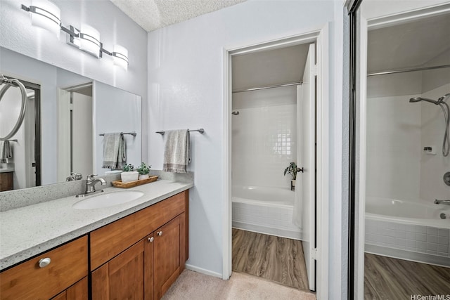 98-1712 Kaahumanu St Unit 11A, Pearl City, HI 96782 - bathroom with tiled shower / bath combo, vanity, a textured ceiling, and baseboards