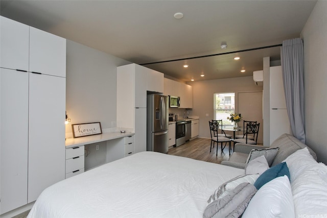 91-3575 Kamolehonua St Unit 902, Ewa Beach, HI 96706 - bedroom with stainless steel refrigerator with ice dispenser, light wood-style floors, and recessed lighting