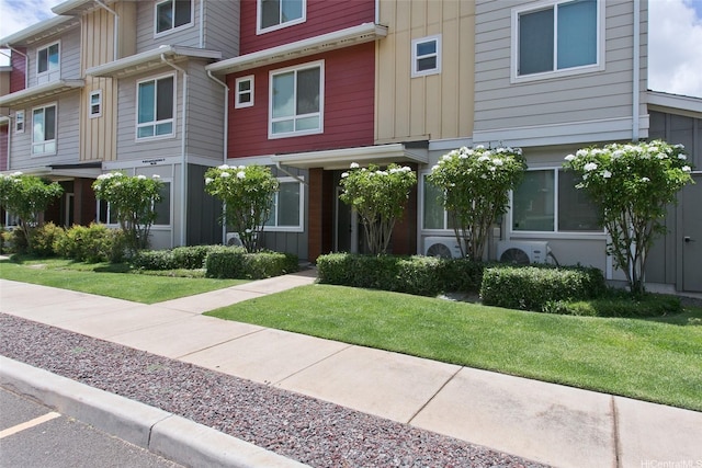 91-3575 Kamolehonua St Unit 902, Ewa Beach, HI 96706 - townhome / multi-family property with board and batten siding, a front lawn, and ac unit