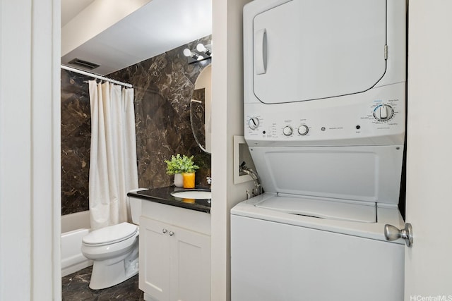 469 Ena Rd Unit 901, Honolulu, HI 96815 - washroom featuring estacked washer and dryer and dark marble finish floors