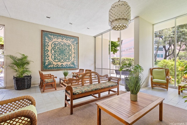 469 Ena Rd Unit 901, Honolulu, HI 96815 - tiled living room with healthy amount of natural light, a chandelier, a textured ceiling, and a wall of windows