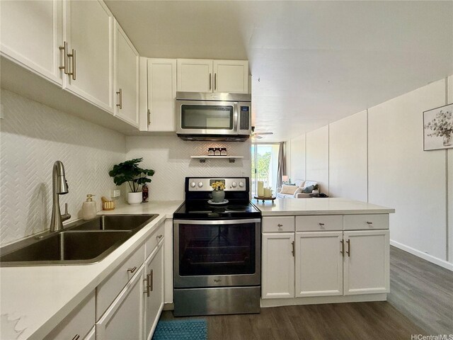 95-2055 Waikalani Pl Unit B204, Mililani, HI 96789 - kitchen with stainless steel appliances, a sink, a peninsula, dark wood-style floors, and white cabinetry