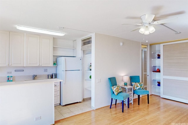 1630 Liholiho St Unit 1203, Honolulu, HI 96822 - kitchen with freestanding refrigerator, open shelves, ceiling fan, light countertops, and light wood-style flooring