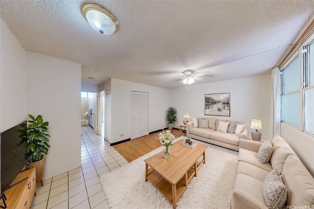 1911 Kalakaua Ave Unit 411, Honolulu, HI 96815 - living area with light tile patterned floors, a ceiling fan, a textured ceiling, and baseboards