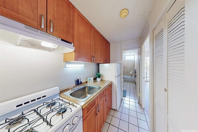 1911 Kalakaua Ave Unit 411, Honolulu, HI 96815 - kitchen featuring white appliances, under cabinet range hood, a sink, light countertops, and light tile patterned floors