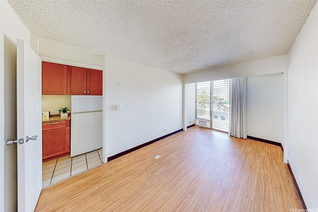 1911 Kalakaua Ave Unit 411, Honolulu, HI 96815 - unfurnished room featuring a textured ceiling, light wood finished floors, and baseboards