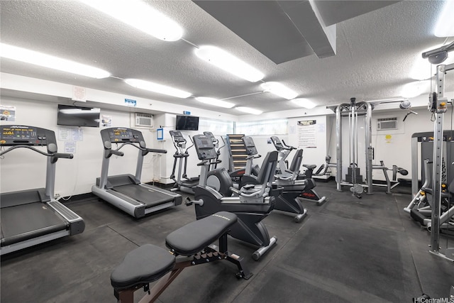 444 Niu St Unit 3806, Honolulu, HI 96815 - workout area featuring a textured ceiling and an AC wall unit