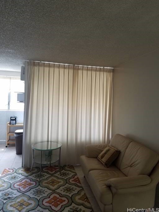 747 Amana St Unit 1515, Honolulu, HI 96814 - living room featuring a textured ceiling and light tile patterned floors