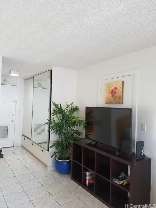 747 Amana St Unit 1515, Honolulu, HI 96814 - living area featuring a textured ceiling and tile patterned flooring