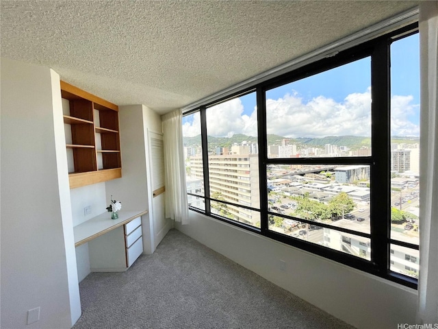 1221 Victoria St Unit 1205, Honolulu, HI 96814 - unfurnished dining area featuring a view of city, light carpet, and a textured ceiling