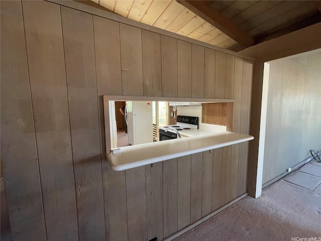 1676 Hoonipo St, Pearl City, HI 96782 - kitchen with freestanding refrigerator, electric stove, wooden walls, wooden ceiling with exposed beams, and light carpet