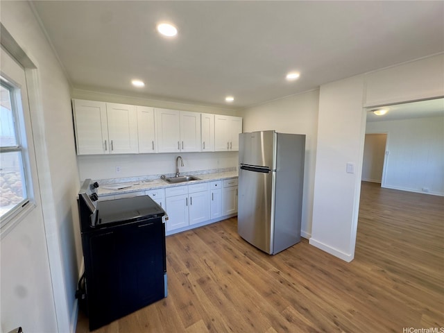 1846 Kilohi St, Honolulu, HI 96819 - kitchen featuring freestanding refrigerator, range with electric stovetop, white cabinets, light wood finished floors, and recessed lighting