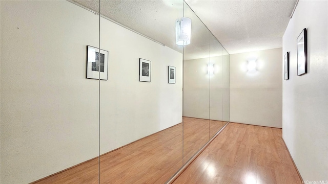 55 S Kukui St Unit D2701, Honolulu, HI 96813 - hall featuring light wood-type flooring and a textured ceiling