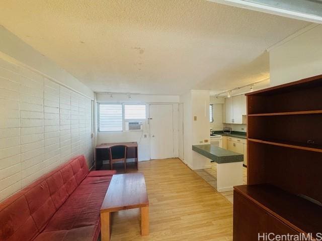 417 Nohonani St Unit 513, Honolulu, HI 96815 - corridor with light wood-style floors, a textured ceiling, and track lighting