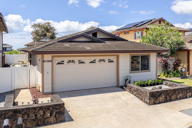 94-1444 Okupu St, Waipahu, HI 96797 - view of front of home with driveway, a gate, and an attached garage