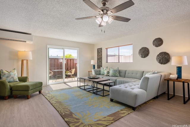 94-1444 Okupu St, Waipahu, HI 96797 - living area with a wall unit AC, a textured ceiling, wood finished floors, and ceiling fan