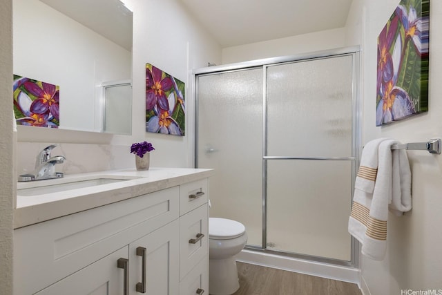 94-1444 Okupu St, Waipahu, HI 96797 - full bathroom featuring vanity, wood finished floors, a shower stall, and toilet