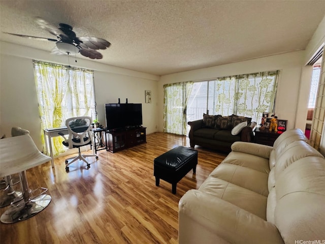 1615 Wilder Ave Unit 401, Honolulu, HI 96822 - living room featuring healthy amount of natural light, wood finished floors, a textured ceiling, and ceiling fan