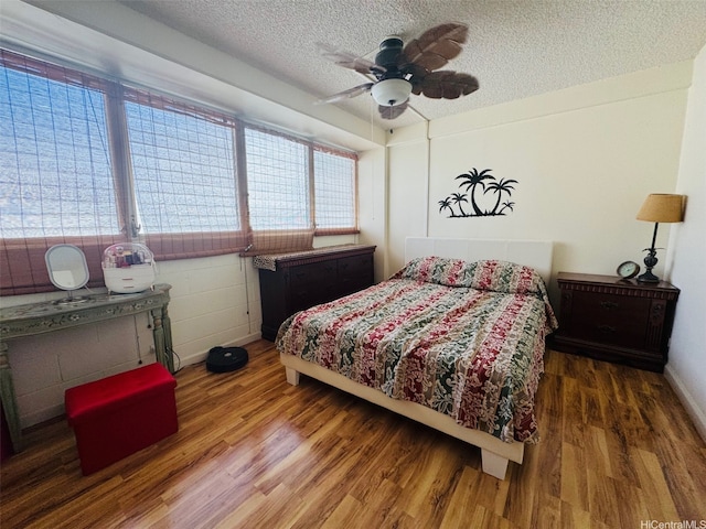 1615 Wilder Ave Unit 401, Honolulu, HI 96822 - bedroom featuring a textured ceiling, wood finished floors, ceiling fan, and baseboards