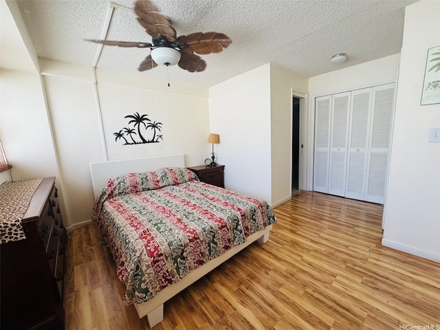 1615 Wilder Ave Unit 401, Honolulu, HI 96822 - bedroom featuring wood finished floors, a textured ceiling, baseboards, ceiling fan, and a closet
