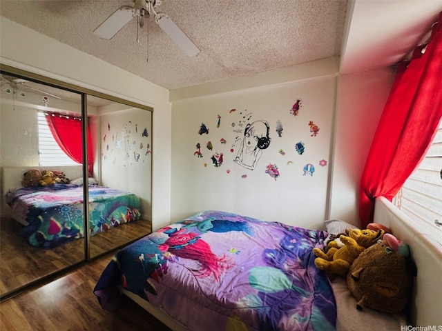 1615 Wilder Ave Unit 401, Honolulu, HI 96822 - bedroom with wood finished floors, a textured ceiling, a closet, and a ceiling fan
