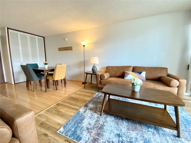 1655 Makaloa St Unit 911, Honolulu, HI 96814 - living room with wood finished floors and a textured ceiling