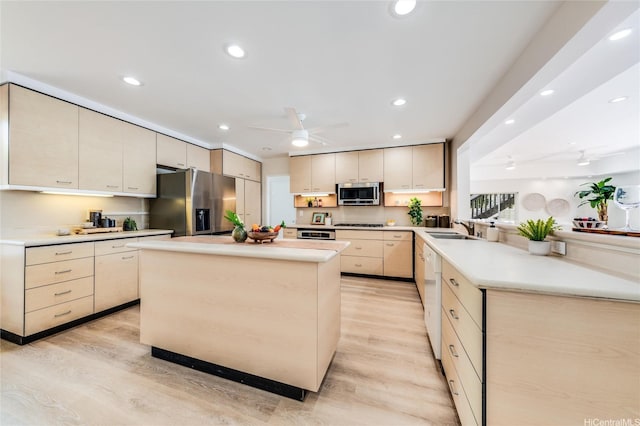 902 Wanaao Rd, Kailua, HI 96734 - kitchen featuring appliances with stainless steel finishes, light wood finished floors, ceiling fan, a peninsula, and recessed lighting
