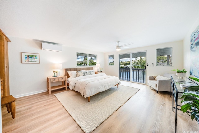 902 Wanaao Rd, Kailua, HI 96734 - bedroom with a wall mounted air conditioner, access to outside, light wood-type flooring, and baseboards