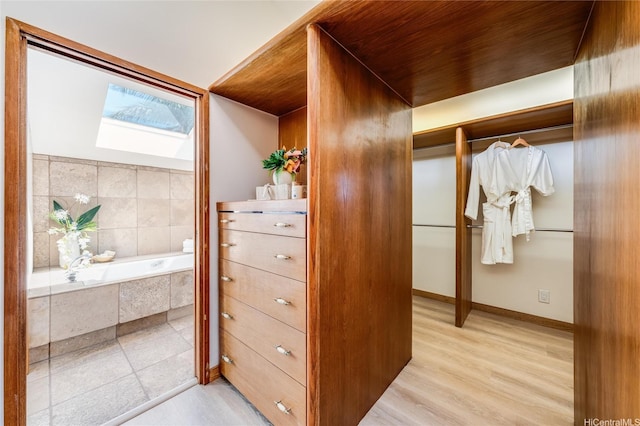 902 Wanaao Rd, Kailua, HI 96734 - spacious closet featuring a skylight and light wood-style floors