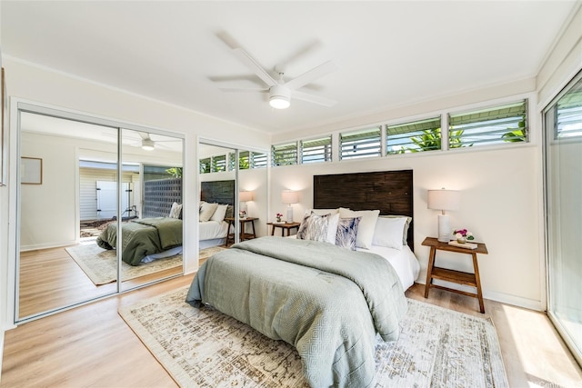 902 Wanaao Rd, Kailua, HI 96734 - bedroom with multiple windows, light wood-style flooring, a ceiling fan, and multiple closets