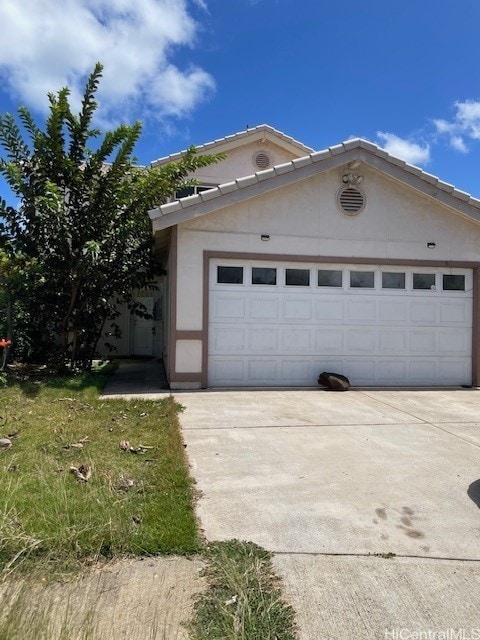 91-1501 Keonekapu St, Ewa Beach, HI 96706 - view of front facade featuring concrete driveway and stucco siding