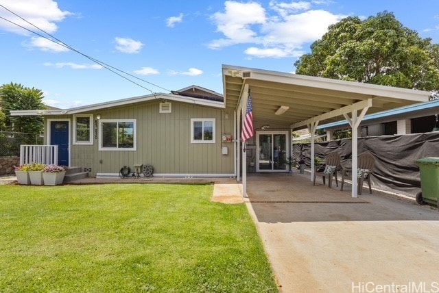 87-230 Holopono St, Waianae, HI 96792 - rear view of property with concrete driveway, a carport, and a lawn