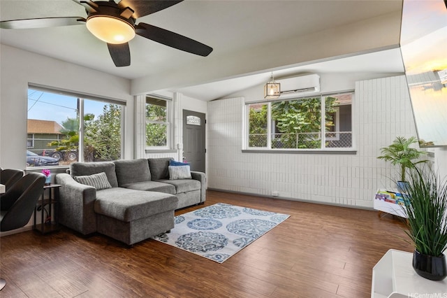 87-230 Holopono St, Waianae, HI 96792 - living area featuring an AC wall unit, a ceiling fan, wood finished floors, healthy amount of natural light, and vaulted ceiling