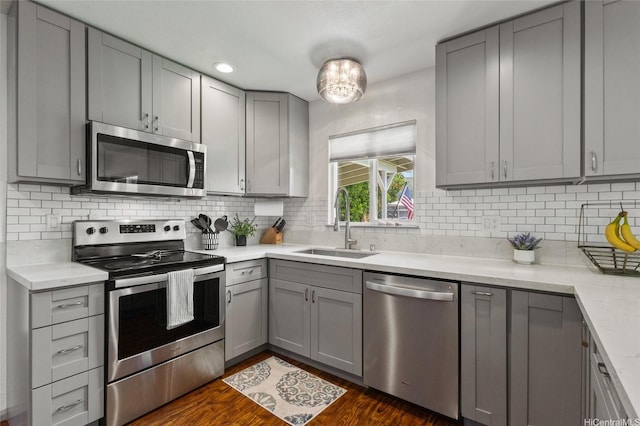 87-230 Holopono St, Waianae, HI 96792 - kitchen with stainless steel appliances, gray cabinetry, a sink, and dark wood-style flooring
