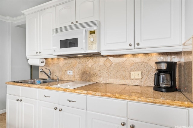 134 Kapahulu Ave Unit 609, Honolulu, HI 96815 - kitchen featuring white appliances, tile countertops, white cabinetry, and ornamental molding