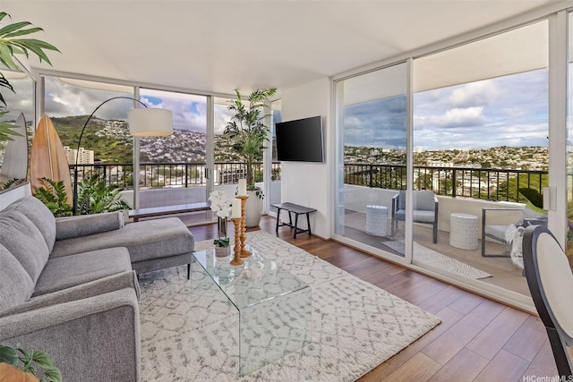 2825 S King St Unit 1403, Honolulu, HI 96826 - living area with plenty of natural light, wood finished floors, and a wall of windows