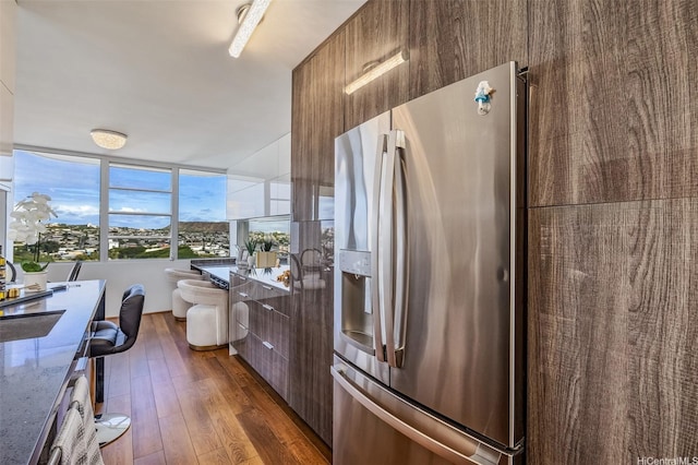 2825 S King St Unit 1403, Honolulu, HI 96826 - kitchen with modern cabinets, stainless steel refrigerator with ice dispenser, dark wood-style floors, and stone counters