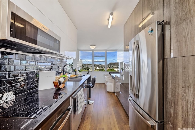 2825 S King St Unit 1403, Honolulu, HI 96826 - kitchen featuring stainless steel appliances, dark wood-style flooring, a sink, and modern cabinets