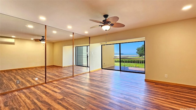 6133 Summer St Unit 6133B, Honolulu, HI 96821 - unfurnished bedroom with access to outside, wood finished floors, a wall mounted AC, baseboards, and recessed lighting