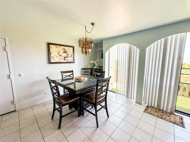84-664 Ala Mahiku St Unit 196A, Waianae, HI 96792 - dining space featuring arched walkways, a chandelier, light tile patterned floors, and a textured ceiling