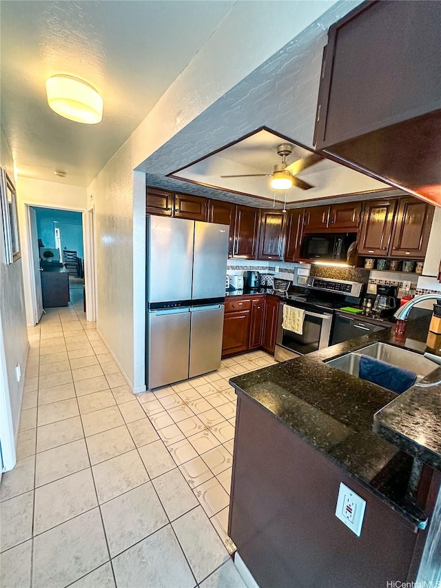 84-664 Ala Mahiku St Unit 196A, Waianae, HI 96792 - kitchen featuring appliances with stainless steel finishes, a sink, light tile patterned floors, ceiling fan, and dark stone counters