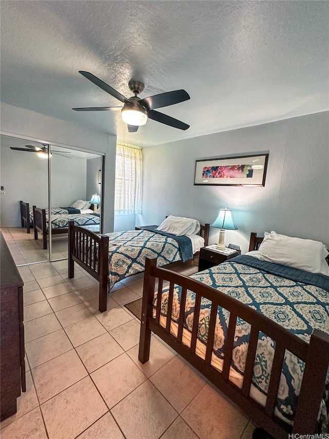 84-664 Ala Mahiku St Unit 196A, Waianae, HI 96792 - bedroom featuring a textured ceiling, light tile patterned floors, a closet, and a ceiling fan